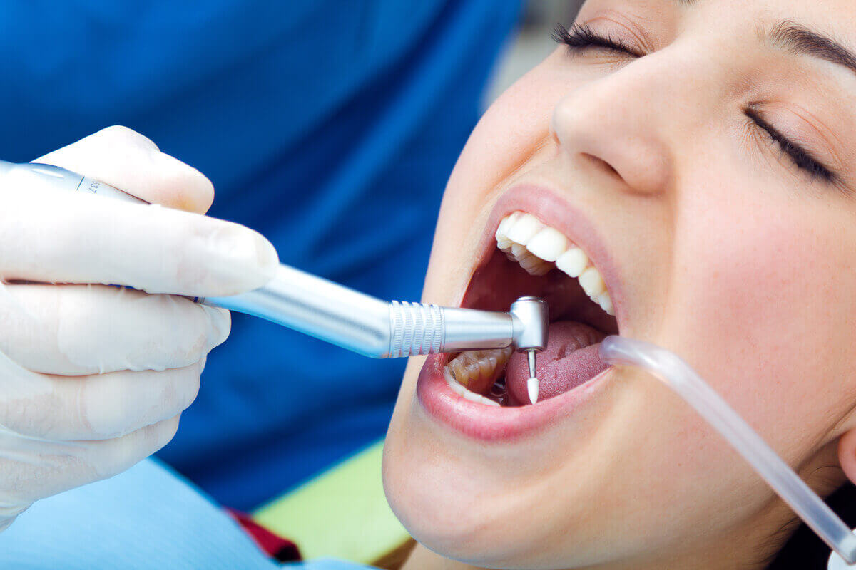 dental professional performing a root canal procedure to save an infected tooth.